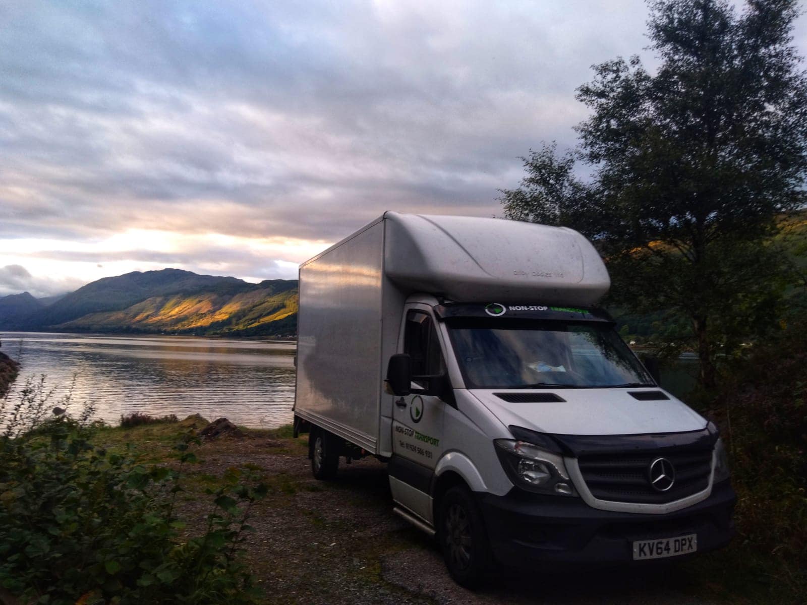 Non-Stop Transport car infront of a river